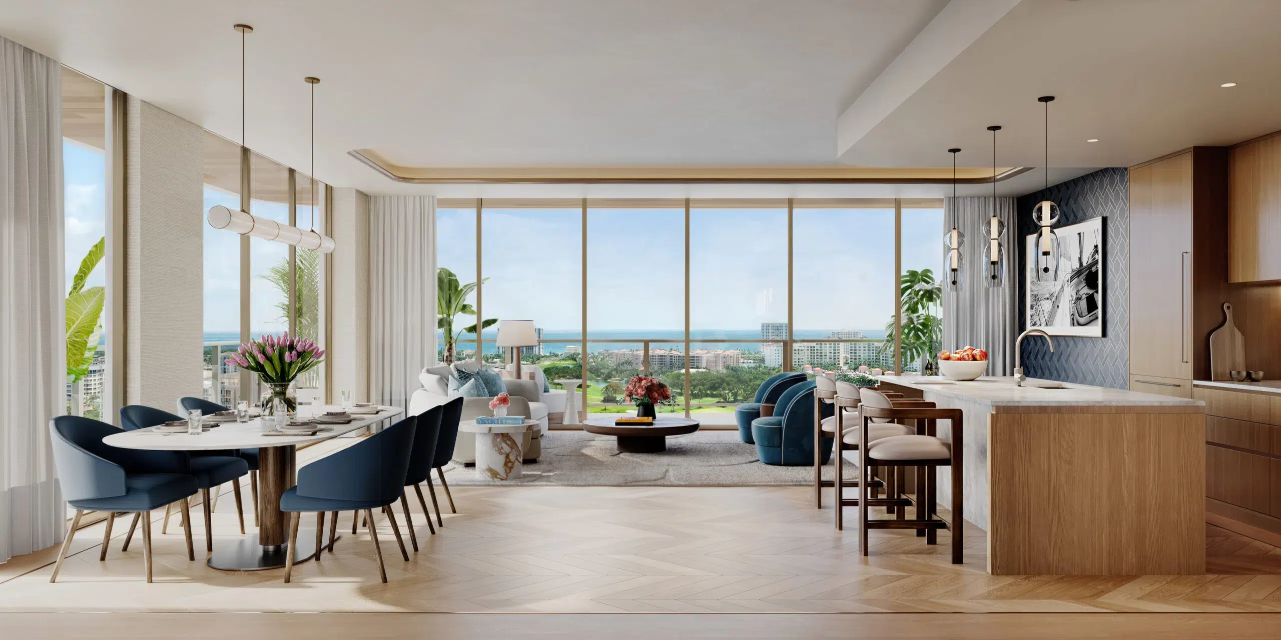 Open-plan living area with a dining table and kitchen island inside a new luxury condo at Mr. C Boca Raton.