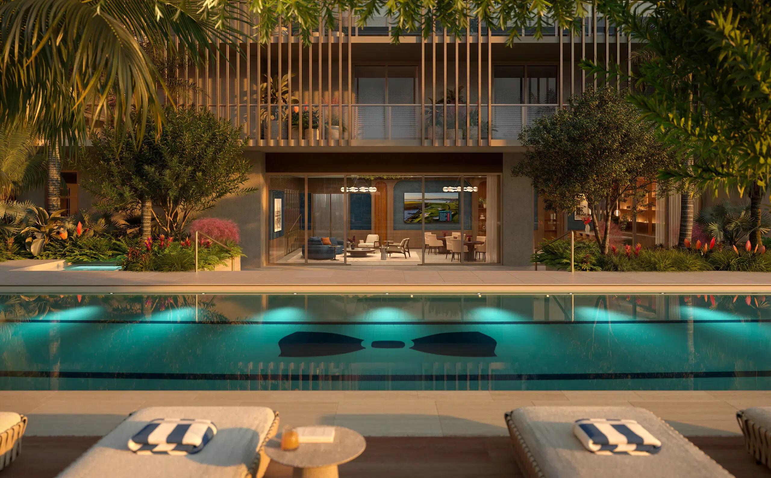 Outdoor pool deck with Mr. C-branded lap pool and lounge chairs in Boca Raton.