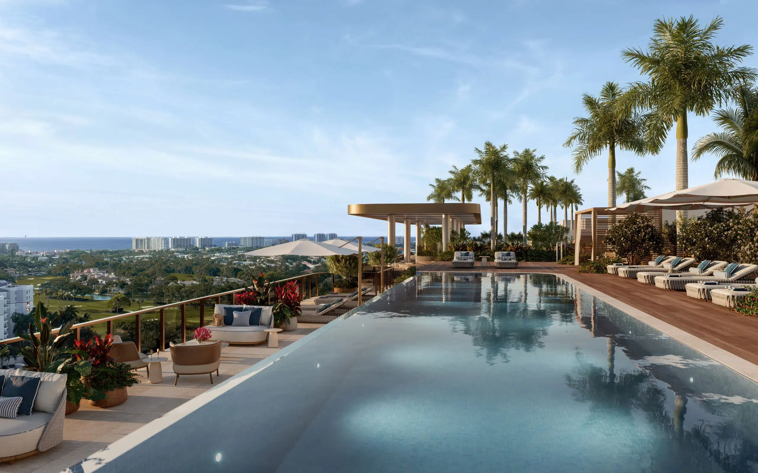 Rooftop infinity pool and lounge chairs overlooking the ocean at Mr. C Boca Raton luxury condominiums.