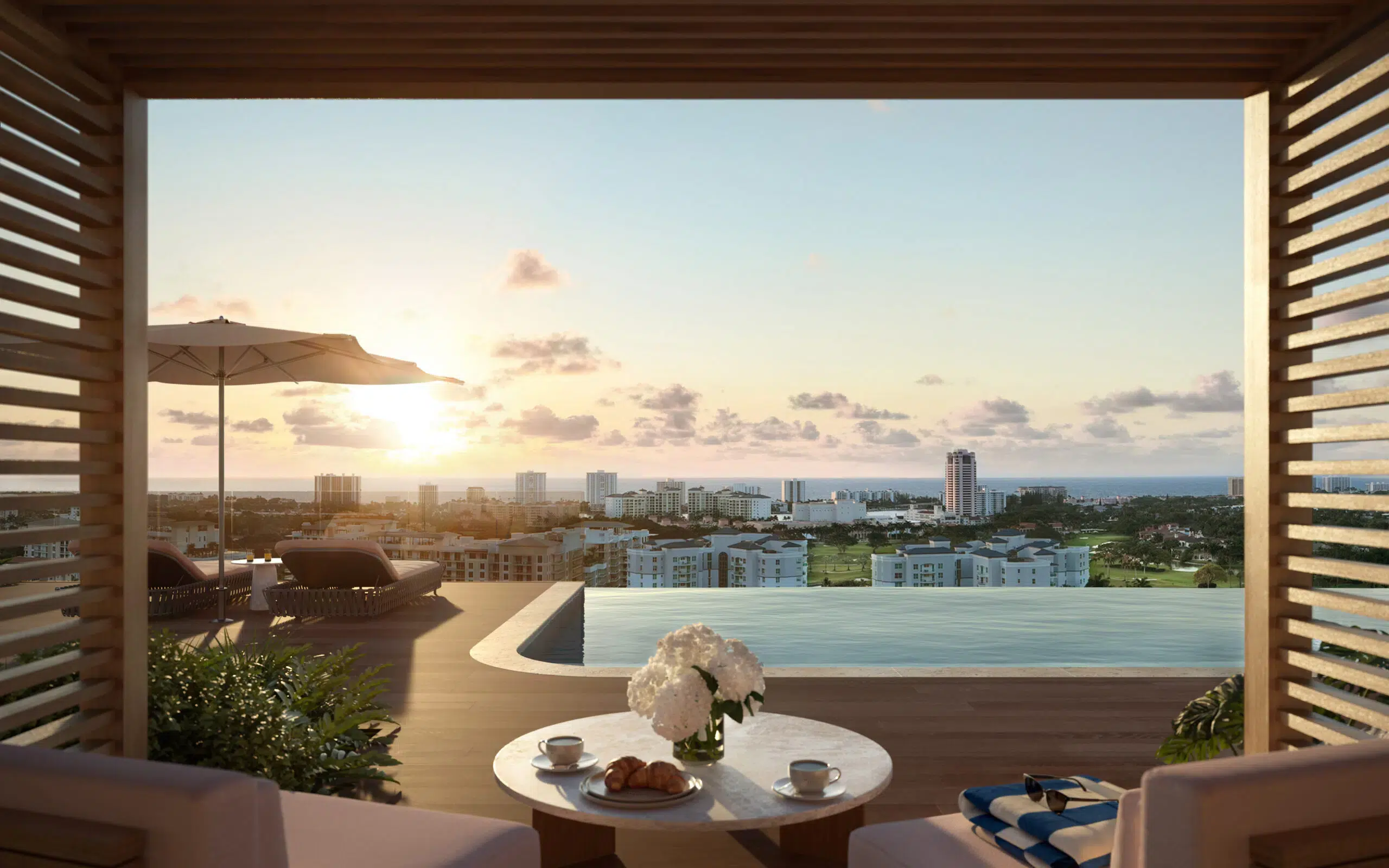 Cabana view of an infinity pool overlooking downtown Boca Raton at sunset: Mr. C Residences.